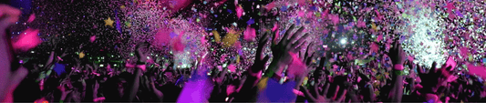 Pink Confetti Showering a Crowd of People Partying with their Hands in the Air
