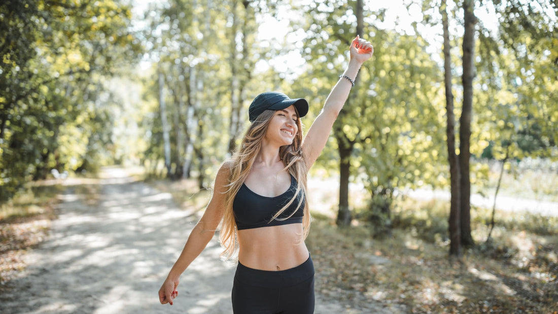 Woman lookig happy and healthy running in the woods