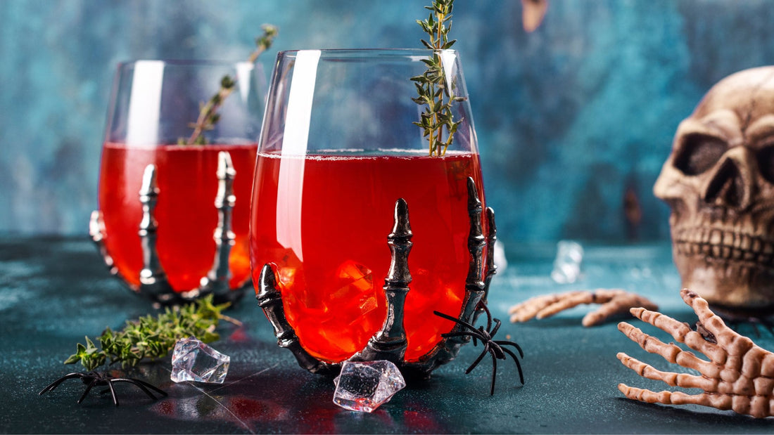 Creepy Cranberry Cider Halloween Mocktail in a skeleton hand glass