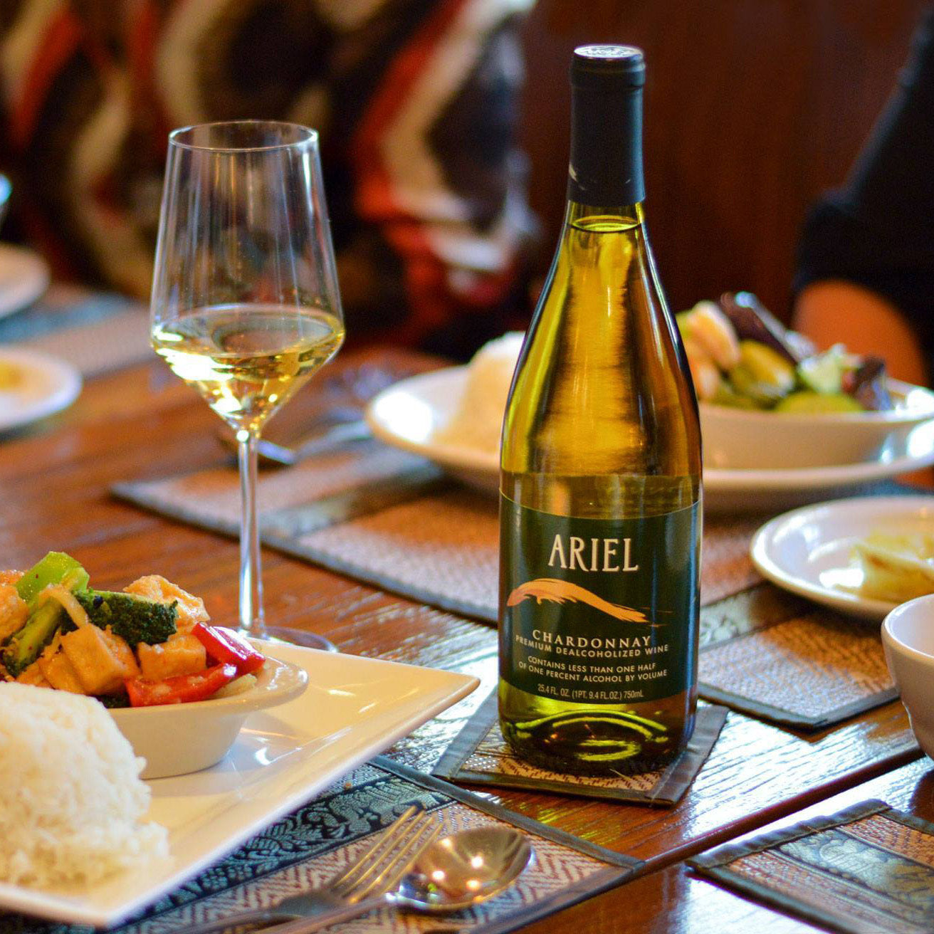 Ariel Non Alcoholic Chardonnay on a table with a meal