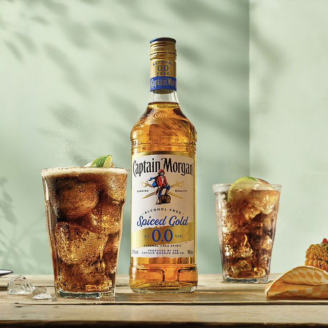 Captain Morgans Alcohol Free Rum bottle next to a glass of alcohol free Captain Morgan and cola